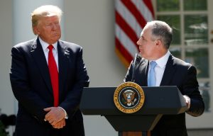 U.S. President Trump listens to EPA Administrator Pruitt after announcing decision to withdraw from Paris Climate Agreement in the White House Rose Garden in Washington